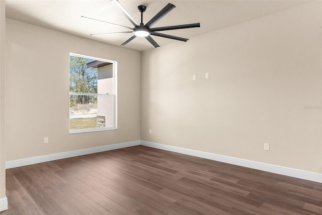 unfurnished room with dark wood-style floors, baseboards, and a ceiling fan