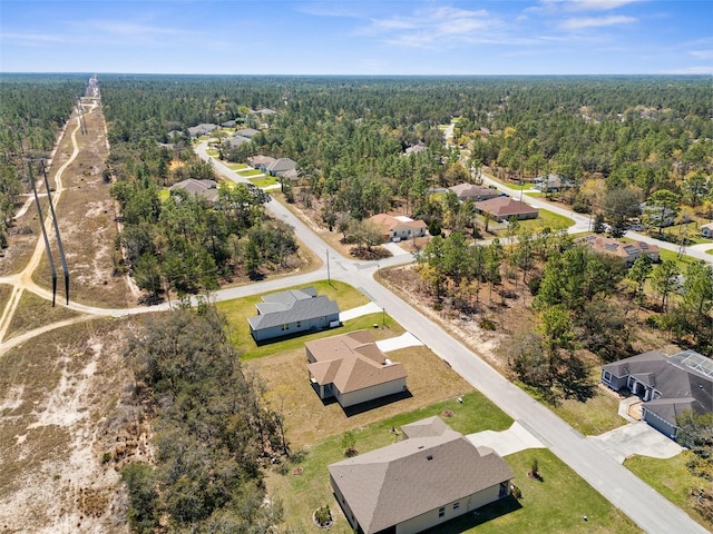 birds eye view of property featuring a forest view