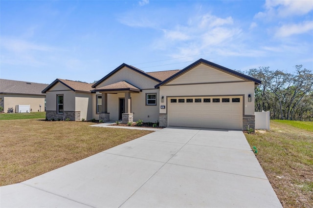 view of front of property with stone siding, an attached garage, and driveway