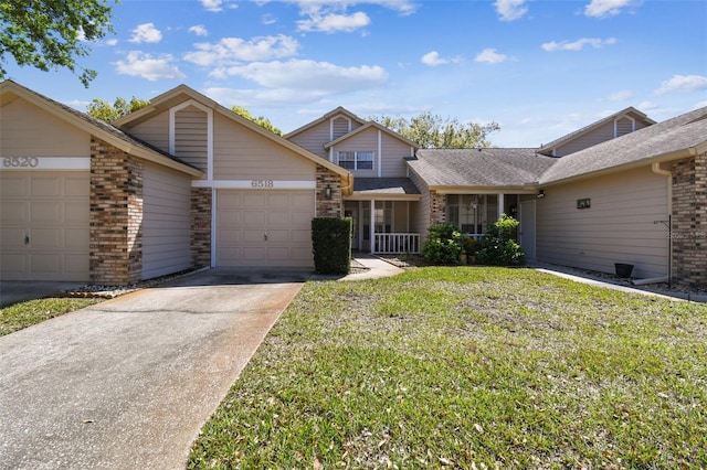 view of front of home with a front yard, roof with shingles, an attached garage, concrete driveway, and brick siding