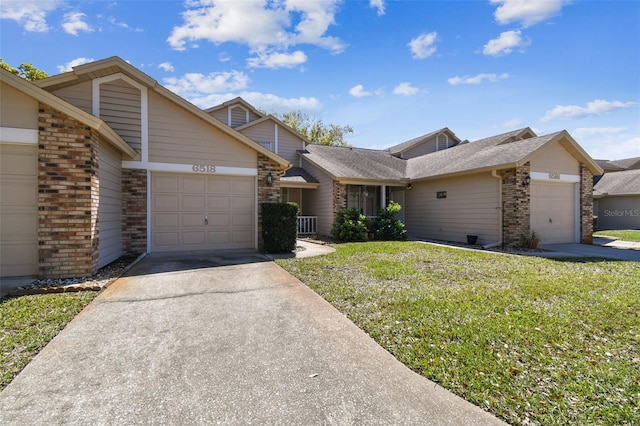 view of front facade with brick siding, driveway, an attached garage, and a front yard