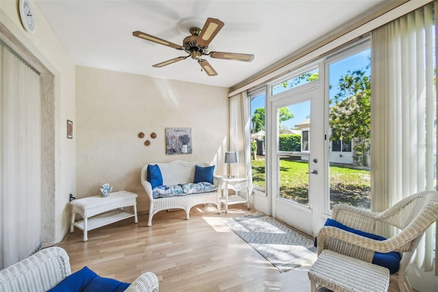 sunroom / solarium with a ceiling fan