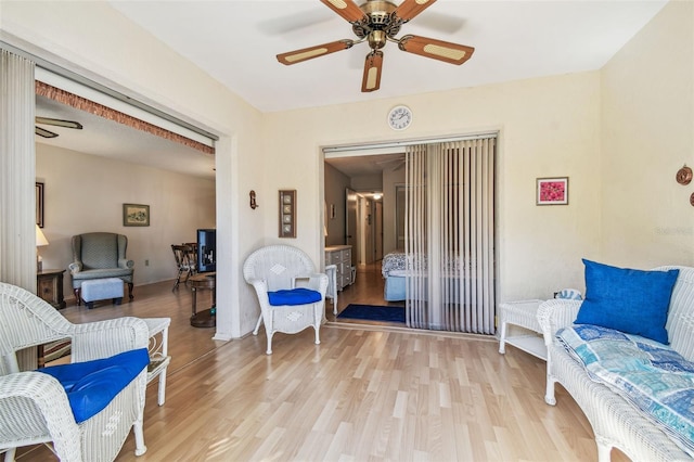 sitting room featuring light wood finished floors and a ceiling fan