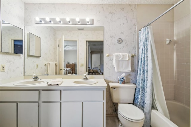 full bathroom with connected bathroom, wallpapered walls, toilet, double vanity, and a sink