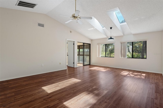 unfurnished room with visible vents, wood finished floors, and a skylight