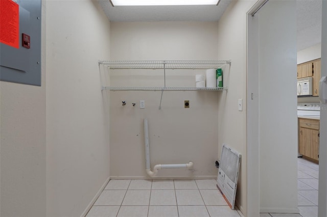 laundry area featuring laundry area, hookup for a washing machine, light tile patterned flooring, and electric dryer hookup