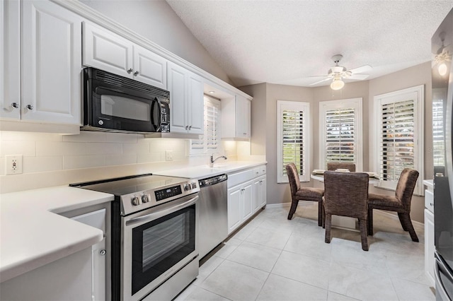 kitchen with ceiling fan, light countertops, decorative backsplash, appliances with stainless steel finishes, and white cabinetry