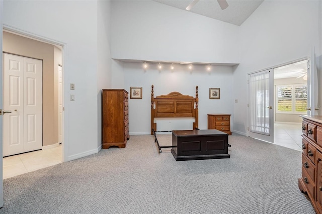 tiled bedroom with baseboards, high vaulted ceiling, and carpet