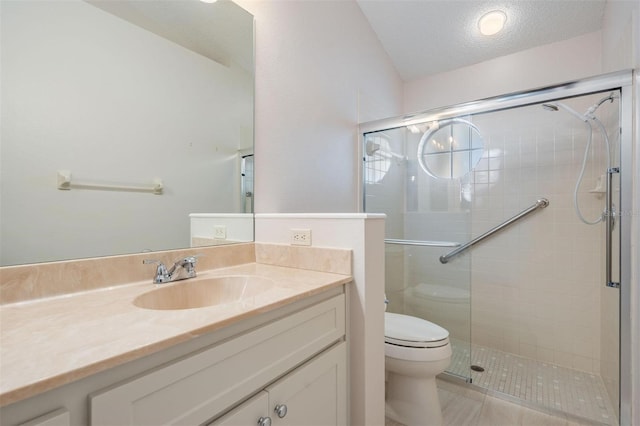 full bath with toilet, a stall shower, vanity, and a textured ceiling