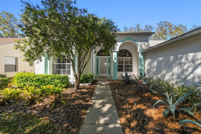 view of exterior entry with stucco siding