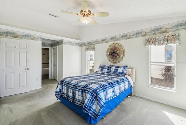 carpeted bedroom featuring visible vents, ceiling fan, baseboards, and lofted ceiling