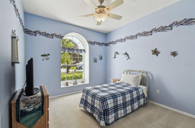 carpeted bedroom with baseboards, a textured ceiling, and ceiling fan