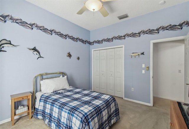 bedroom with visible vents, ceiling fan, baseboards, light carpet, and a closet