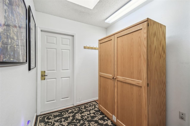 entryway featuring a textured ceiling