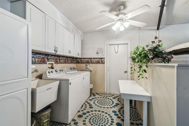 washroom with independent washer and dryer, a textured ceiling, cabinet space, tile walls, and ceiling fan