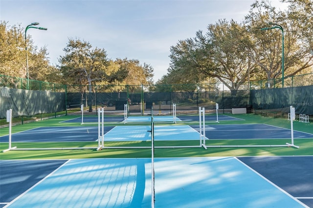 view of sport court featuring fence