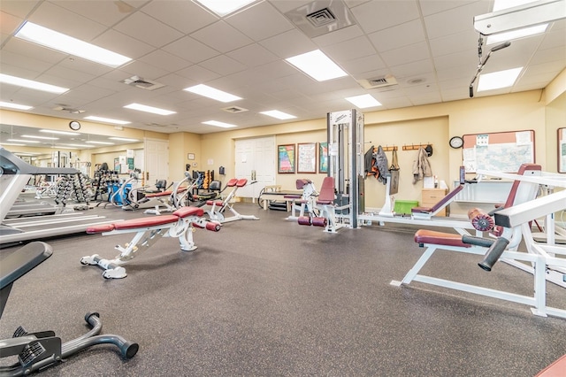 exercise room featuring visible vents and a paneled ceiling