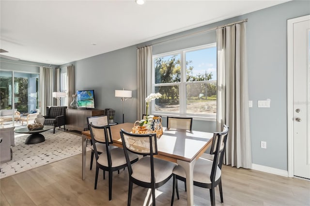 dining room with baseboards and light wood-style floors