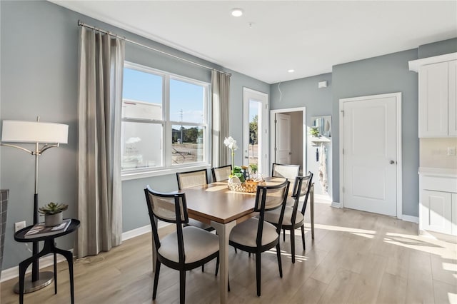 dining room featuring recessed lighting, light wood-type flooring, and baseboards