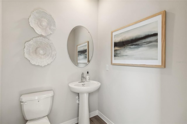 bathroom with baseboards and toilet