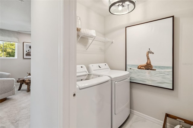 laundry area featuring baseboards, washing machine and dryer, and laundry area