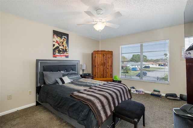 carpeted bedroom featuring a textured ceiling, baseboards, and a ceiling fan