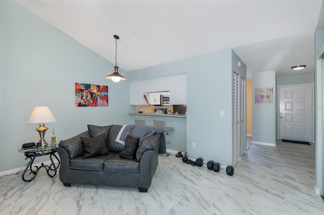 living room with baseboards, marble finish floor, and vaulted ceiling