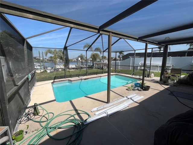 view of pool featuring a fenced in pool, a water view, a lanai, fence, and a patio area