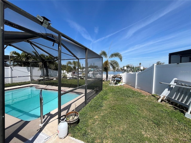 view of pool with a fenced in pool, a fenced backyard, a water view, a lanai, and a lawn