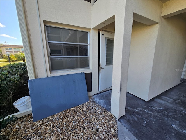 property entrance featuring stucco siding