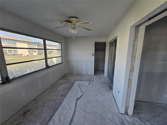 interior space with a closet, a textured ceiling, and ceiling fan