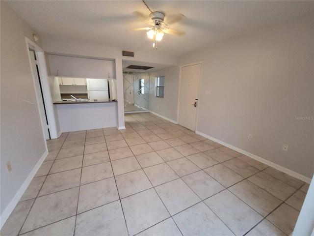 unfurnished living room with visible vents, baseboards, light tile patterned flooring, and a ceiling fan