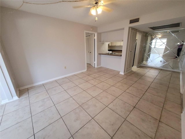 unfurnished living room featuring light tile patterned floors, visible vents, baseboards, and ceiling fan