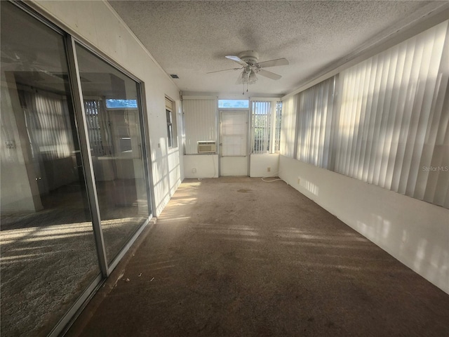 unfurnished sunroom featuring visible vents and ceiling fan