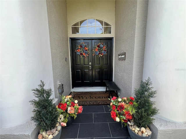 doorway to property with stucco siding