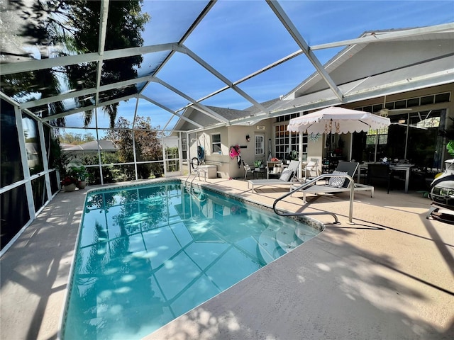 pool featuring a patio area and glass enclosure