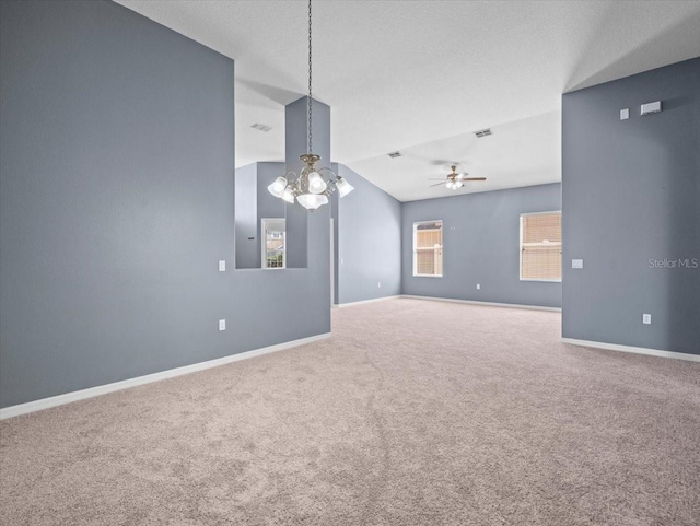 spare room featuring visible vents, baseboards, carpet, and ceiling fan with notable chandelier