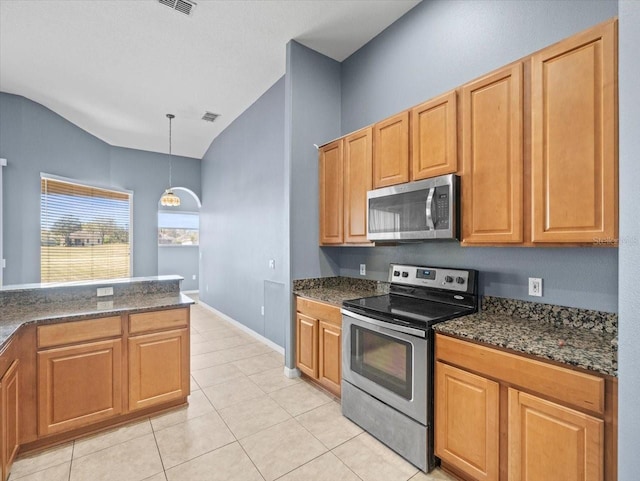 kitchen featuring visible vents, stainless steel appliances, light tile patterned floors, vaulted ceiling, and hanging light fixtures