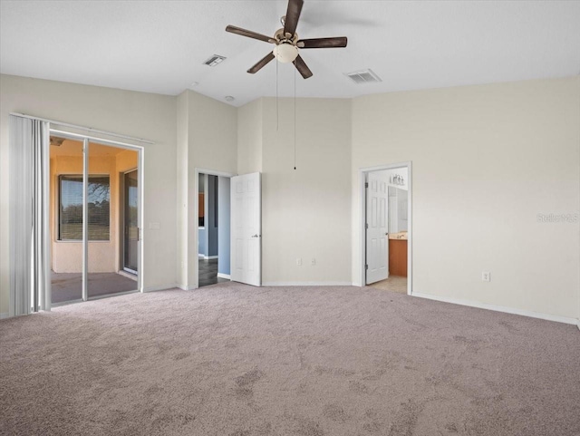 unfurnished bedroom with access to exterior, light colored carpet, and visible vents