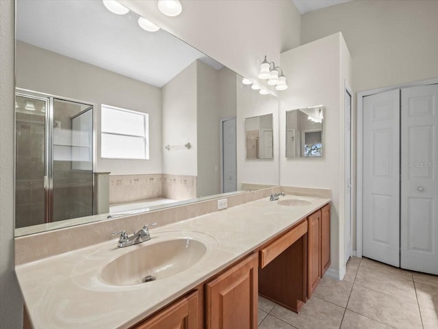 bathroom featuring a garden tub, a sink, a shower stall, tile patterned flooring, and double vanity