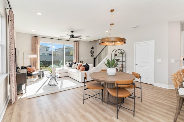 dining space with stairway, baseboards, recessed lighting, ceiling fan, and light wood-style floors