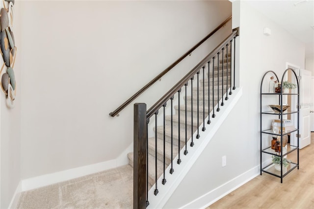 stairs with baseboards and wood finished floors