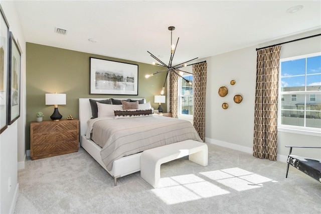 carpeted bedroom featuring visible vents, multiple windows, baseboards, and a chandelier