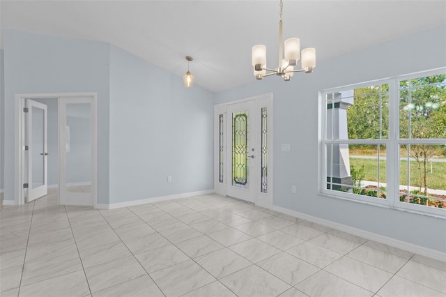 unfurnished room featuring baseboards, lofted ceiling, an inviting chandelier, and french doors