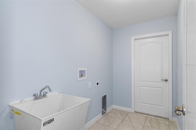 clothes washing area with electric dryer hookup, a sink, baseboards, hookup for a washing machine, and laundry area