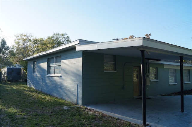 view of side of property featuring an attached carport