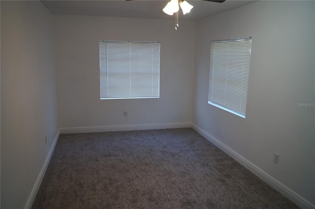 unfurnished room with a ceiling fan, carpet, and baseboards