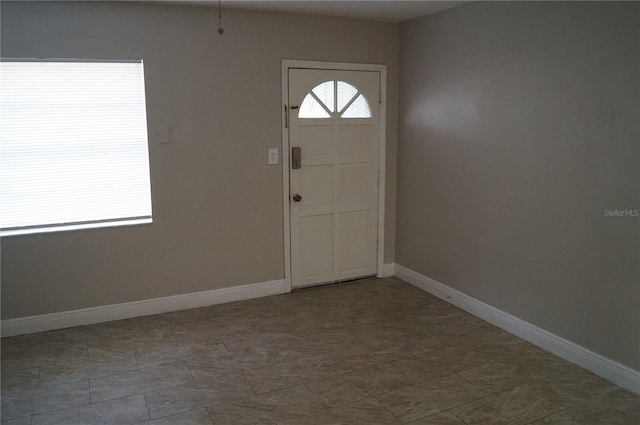 entryway featuring baseboards and a healthy amount of sunlight