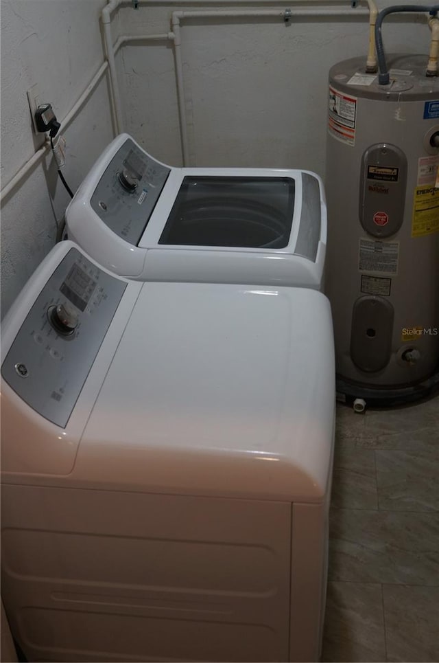 laundry room with water heater, laundry area, and independent washer and dryer