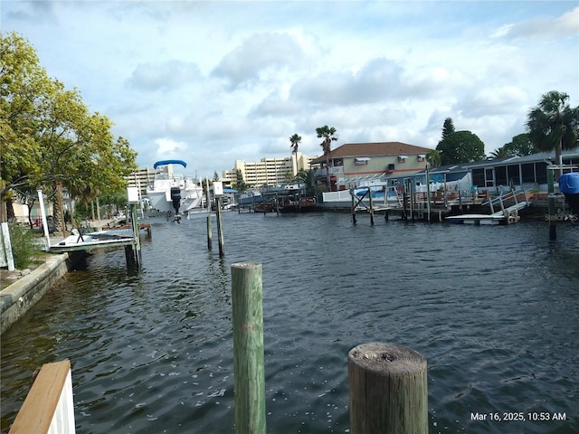 dock area featuring boat lift and a water view